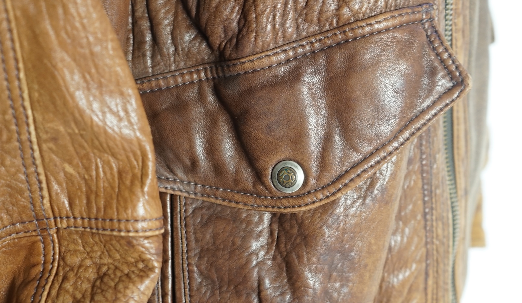 A gentleman's vintage brown leather bomber jacket made by The King, size unknown.